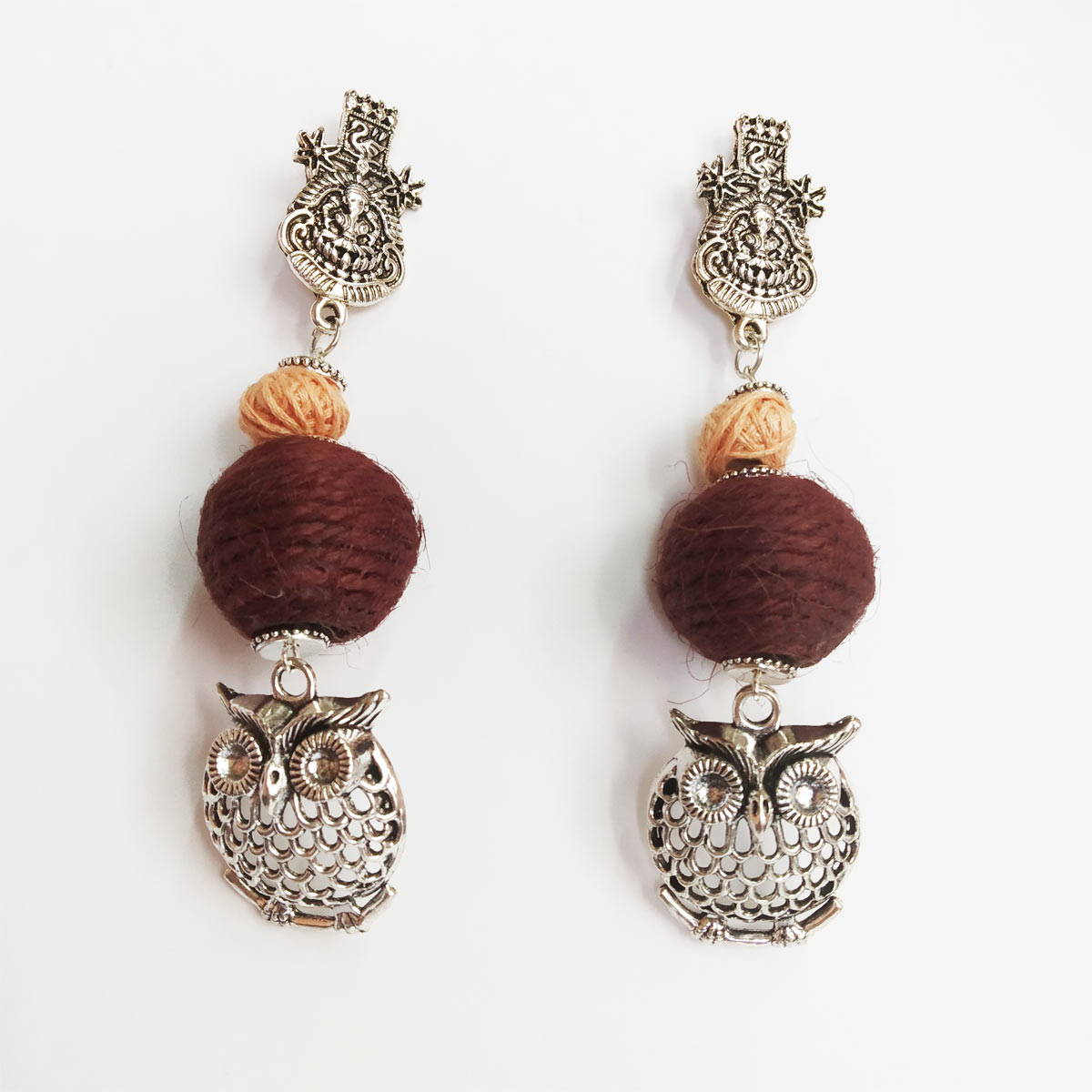 Jute based maroon earrings with owl motif. It is in silver oxidised metal Jute based maroon earrings with owl motif. It is in silver oxidised metal