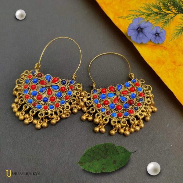 This is a pair of Red and blue stone studded earring. It is having small hanging golden coloured balls. It'll match with your red and blue dress.